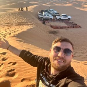 Timimoun tour: 4x4 convoy parked on the orange dunes of the Grand Erg Occidental, Algeria