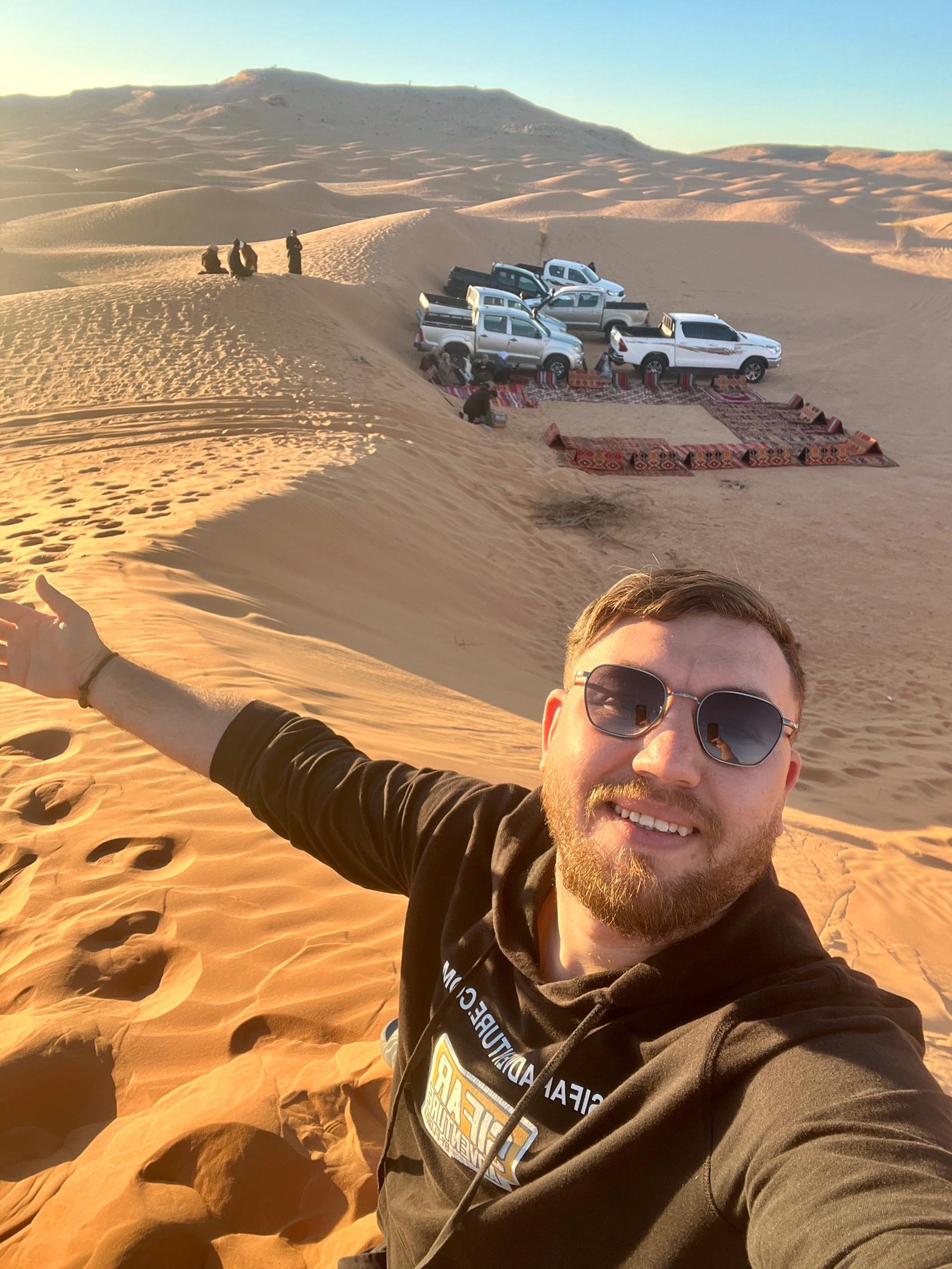 Timimoun tour: 4x4 convoy parked on the orange dunes of the Grand Erg Occidental, Algeria
