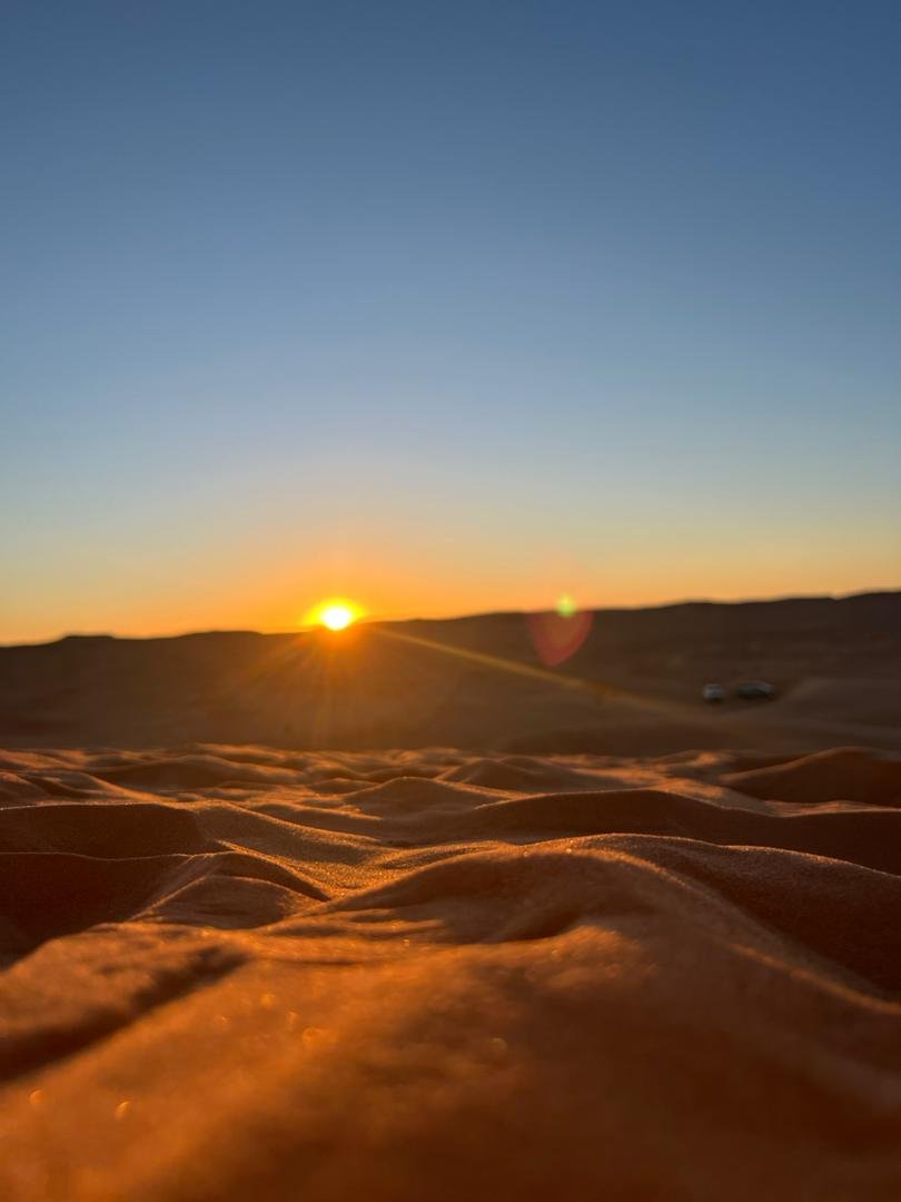 Taghit desert tour: sunrise over rippled sand dunes in the Algerian Sahara